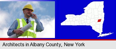 an architect with blueprints, conversing on a cellular phone; Albany County highlighted in red on a map